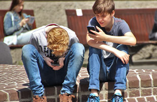 2 boys on cellphones