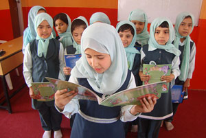 Afghan school girl reading aloud in a classroom