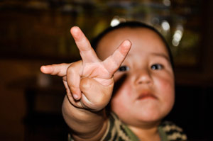 Child holding up 3 fingers